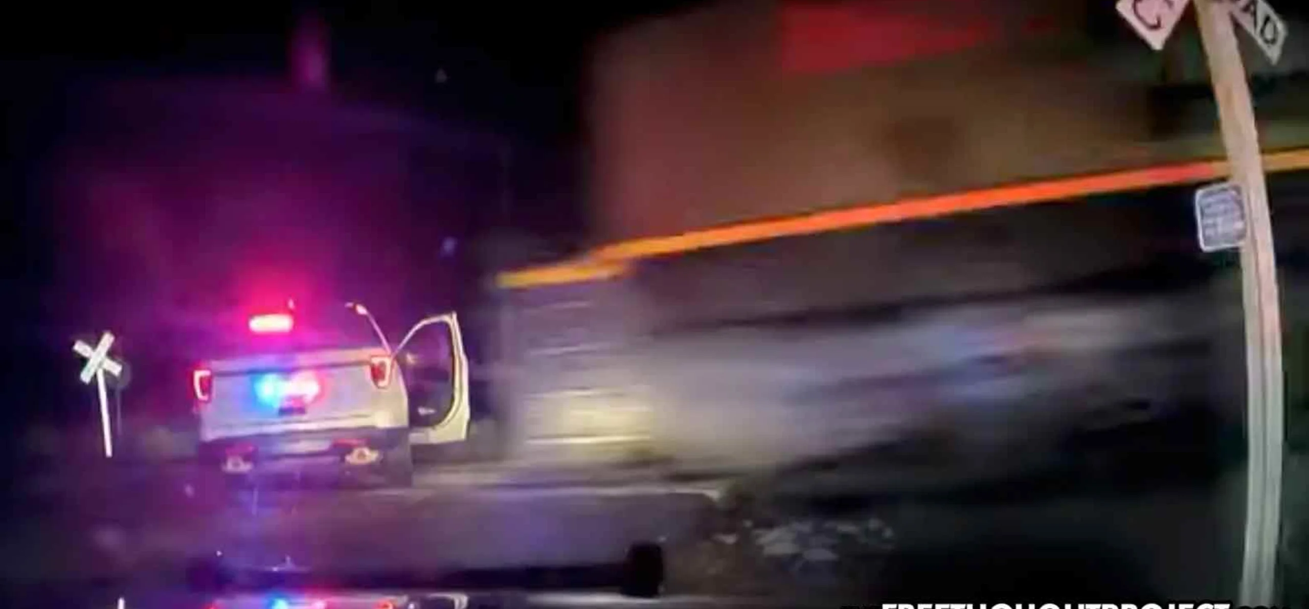 WATCH: Cops Lock Woman in Patrol Car Parked on Train Tracks Before a Train Plows Into It