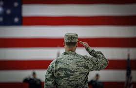 vet in front of flag